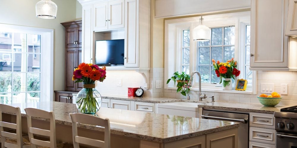 Bright flowers accent white kitchen cabinets