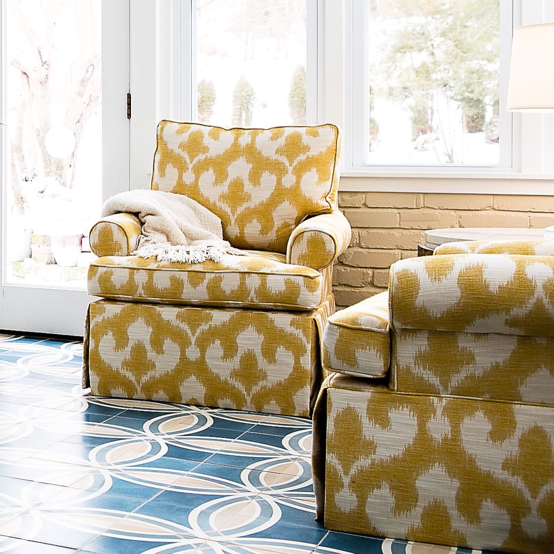 Happy yellow lounge chairs accent blue pattern tile in sunroom