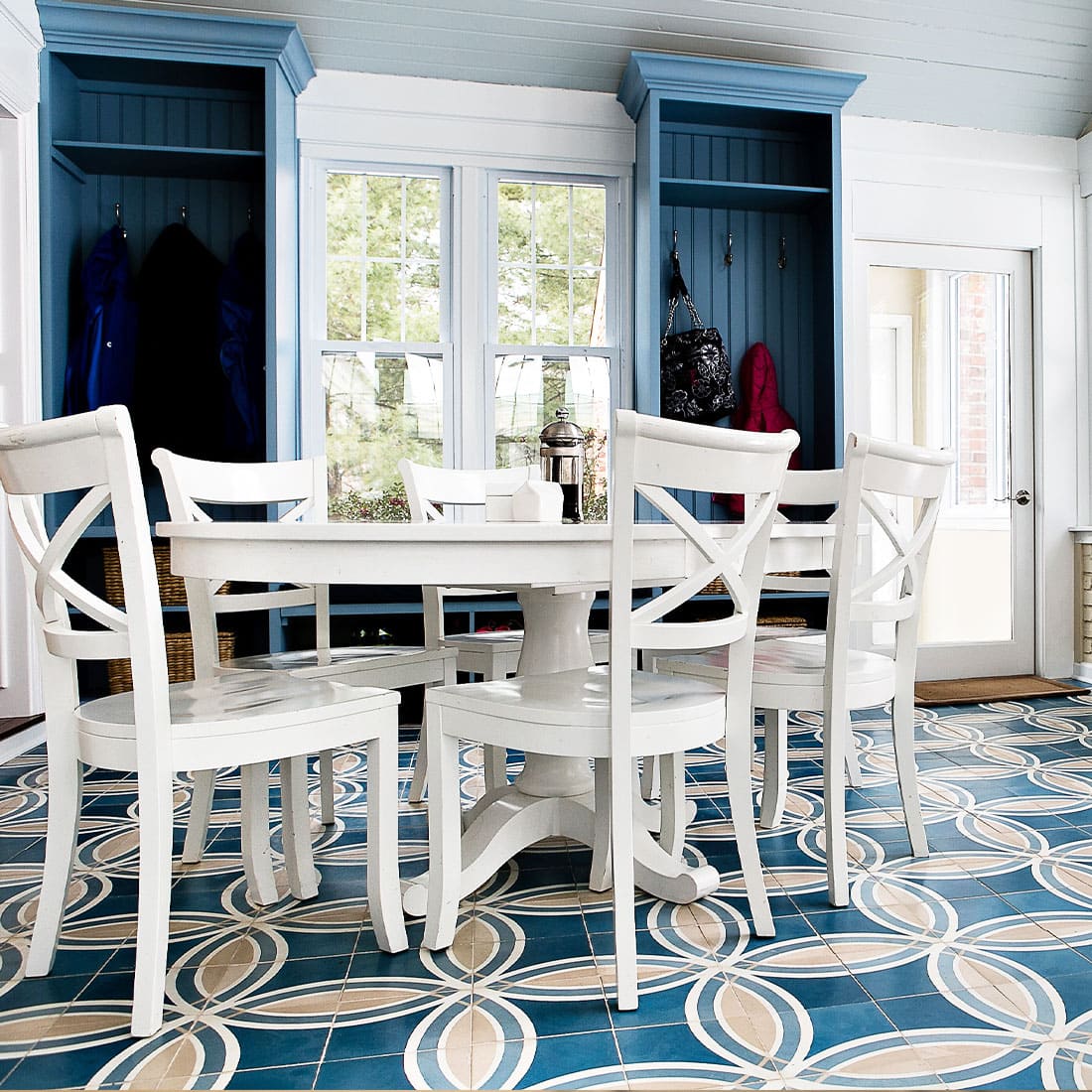 White table set contrast blue and yellow pattern tile in sunroom
